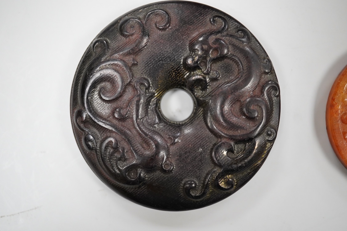 A Chinese pottery jug, two hardstone discs and a metal seal. Jug 17.5cm high